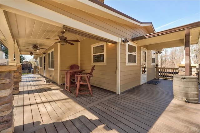 wooden deck with a ceiling fan