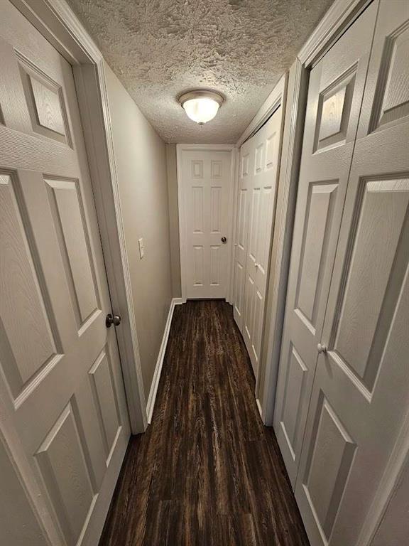 unfurnished bedroom featuring baseboards, carpet floors, and a textured ceiling