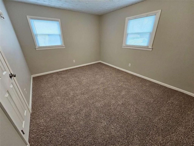 bathroom featuring toilet, a stall shower, and a textured ceiling