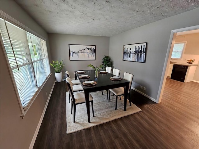 empty room with baseboards, a wealth of natural light, visible vents, and wood finished floors