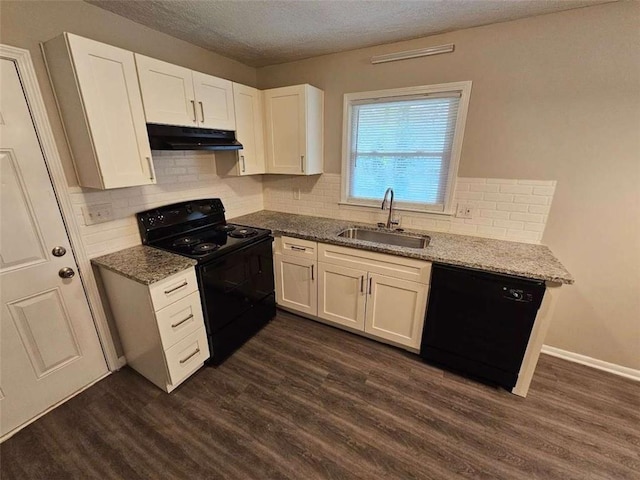 kitchen with under cabinet range hood, black appliances, a sink, and light stone countertops