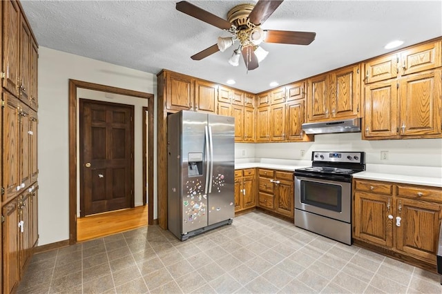 kitchen featuring appliances with stainless steel finishes, under cabinet range hood, brown cabinets, light countertops, and recessed lighting