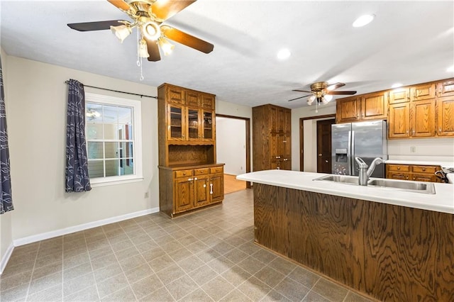 kitchen featuring stainless steel fridge, ceiling fan, a sink, recessed lighting, and baseboards