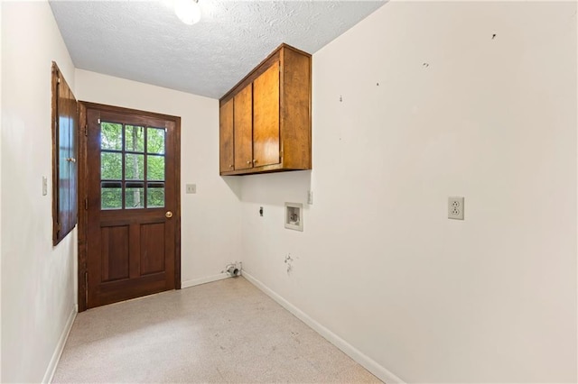 laundry area with cabinet space, baseboards, electric dryer hookup, a textured ceiling, and hookup for a washing machine
