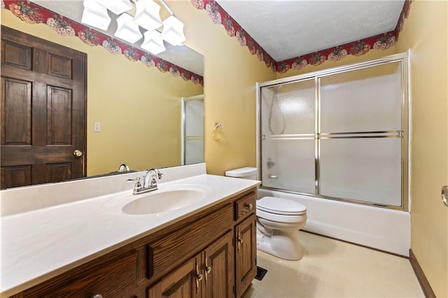 bathroom with toilet, vanity, shower / bath combination with glass door, and a textured ceiling