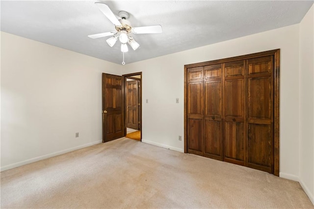 unfurnished bedroom with light carpet and baseboards