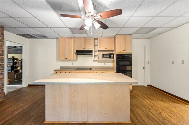 kitchen with black appliances, a drop ceiling, light brown cabinetry, dark wood-style floors, and baseboards