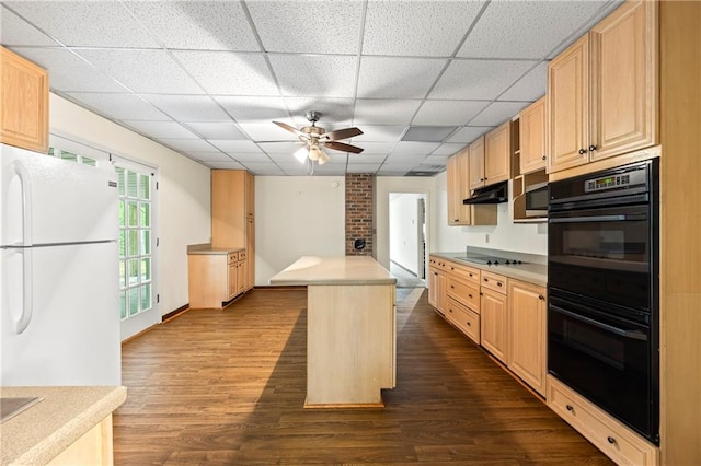 kitchen with black appliances, a ceiling fan, light brown cabinetry, dark wood-style floors, and a drop ceiling