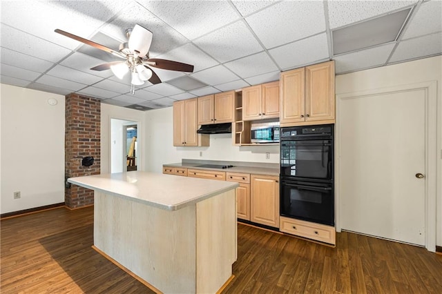 kitchen featuring black appliances, under cabinet range hood, dark wood-style floors, a paneled ceiling, and light brown cabinets