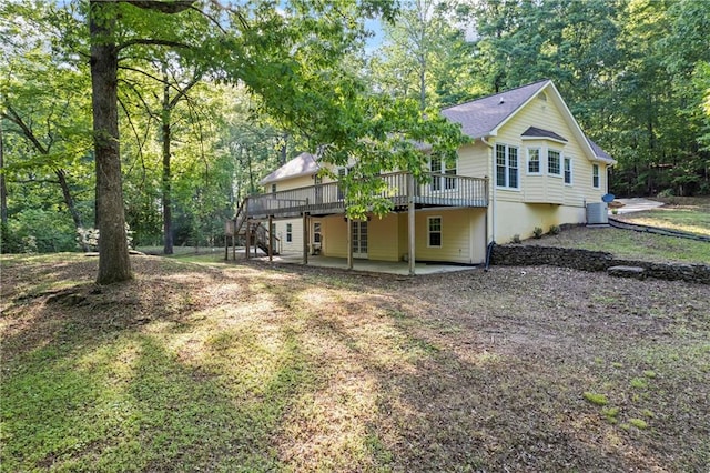 back of property featuring a deck, a patio area, and stairs