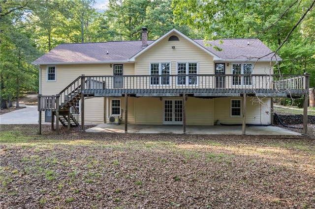 rear view of house featuring a deck, french doors, a patio, and stairway