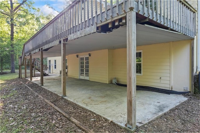 back of property featuring stairway, french doors, and a patio area