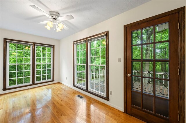 entryway featuring baseboards, healthy amount of natural light, and ceiling fan