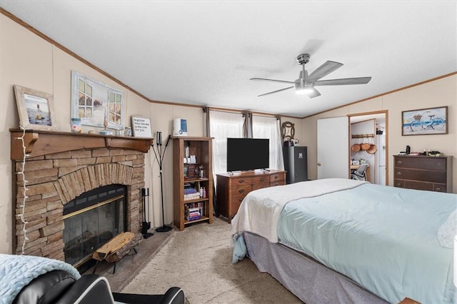 carpeted bedroom featuring a brick fireplace, ornamental molding, and vaulted ceiling