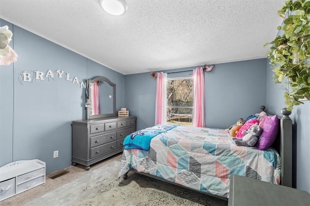 bedroom with carpet floors and a textured ceiling