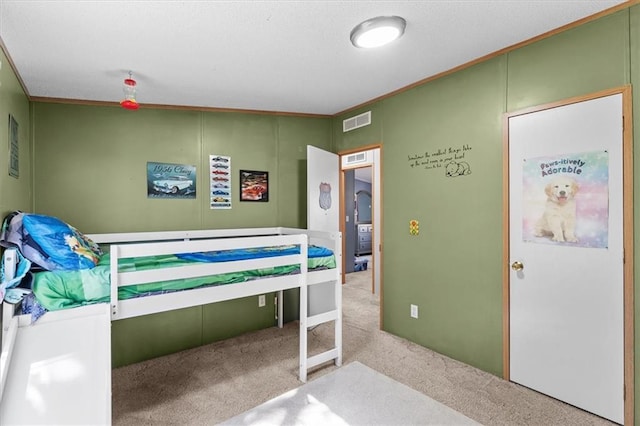 bedroom with ornamental molding, visible vents, and carpet flooring