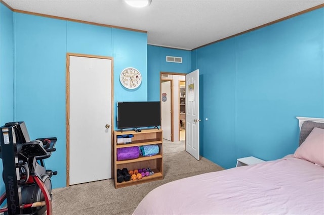 carpeted bedroom with visible vents and ornamental molding