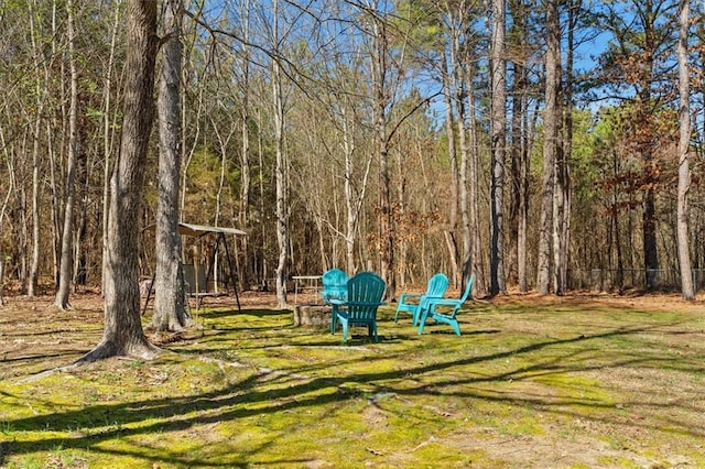 view of yard with a view of trees