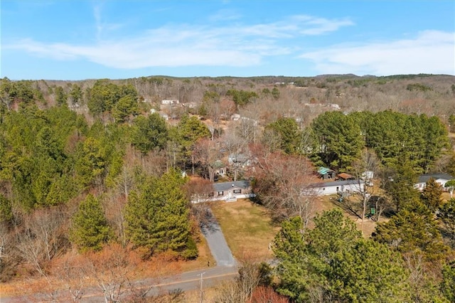 bird's eye view featuring a wooded view