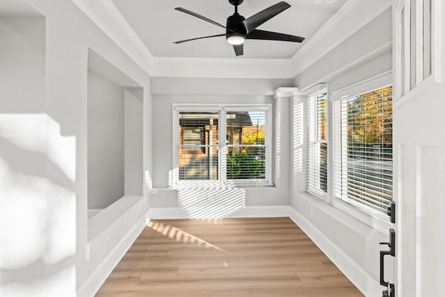 unfurnished sunroom featuring ceiling fan