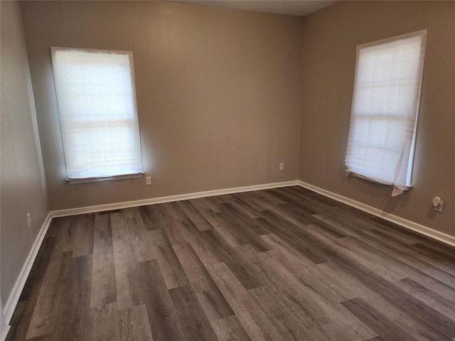 unfurnished room featuring dark hardwood / wood-style flooring