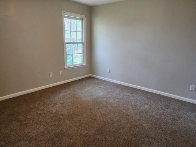 empty room featuring dark colored carpet