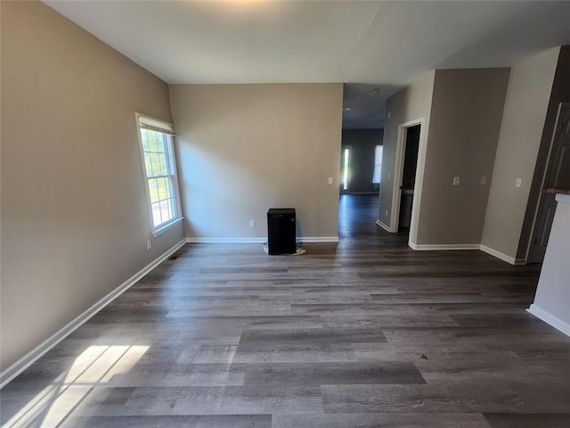 spare room with dark wood-type flooring