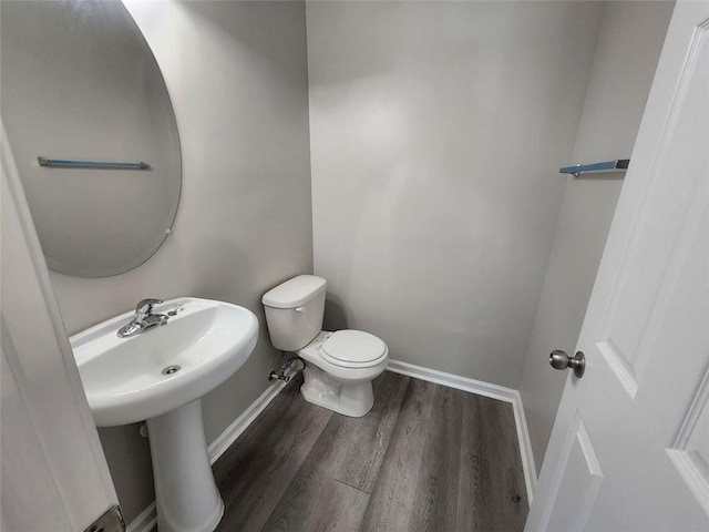 bathroom featuring hardwood / wood-style flooring and toilet