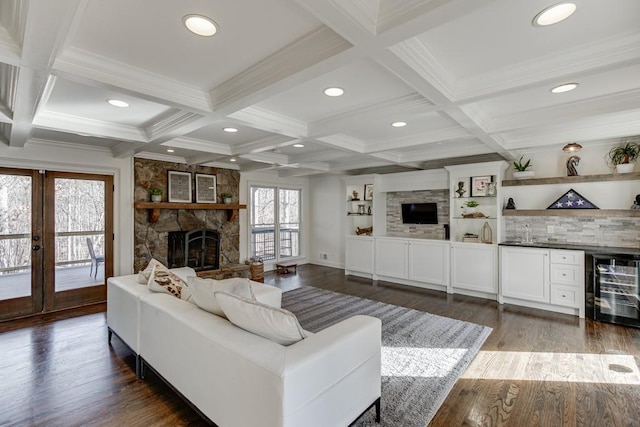 living room with beamed ceiling, dark hardwood / wood-style flooring, a fireplace, and wine cooler