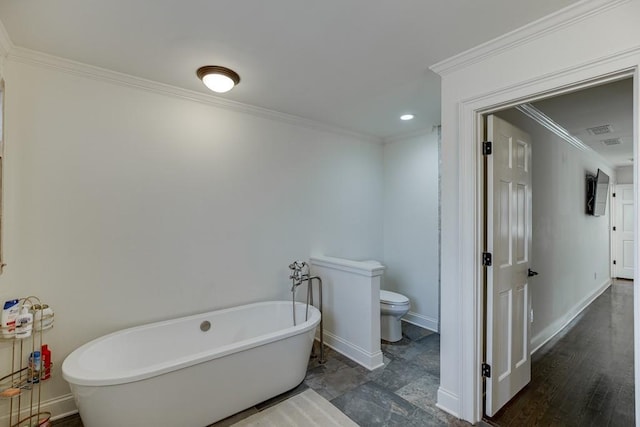 bathroom with a washtub, hardwood / wood-style flooring, toilet, and crown molding