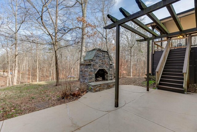 view of patio / terrace featuring an outdoor stone fireplace