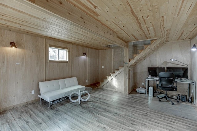 unfurnished room featuring wood walls, light wood-type flooring, wood ceiling, and vaulted ceiling