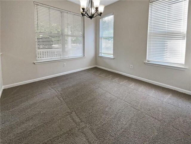 unfurnished room featuring dark carpet