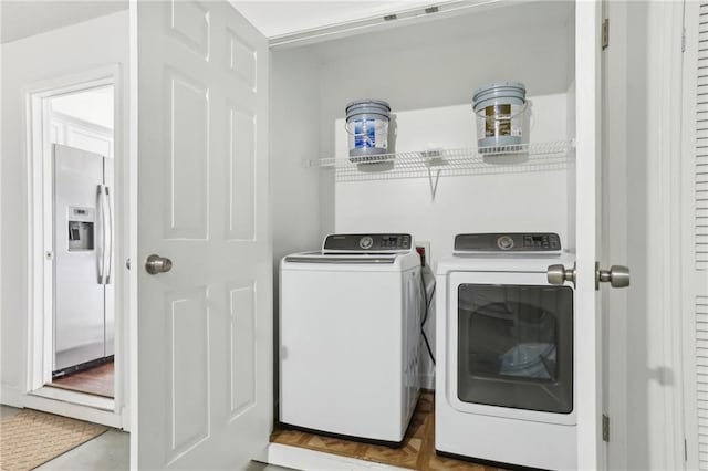 laundry area with parquet flooring and washing machine and clothes dryer