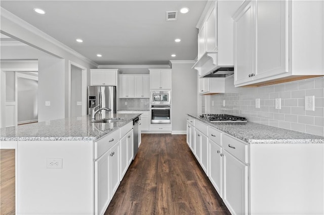 840 Champagne Ln, Hoschton, GA 30548 - kitchen featuring appliances with stainless steel finishes, a sink, white cabinets, tasteful backsplash, and ornamental molding