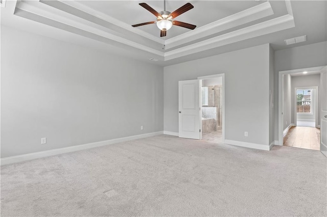 840 Champagne Ln, Hoschton, GA 30548 - unfurnished bedroom with a tray ceiling, light colored carpet, baseboards, connected bathroom, and ornamental molding