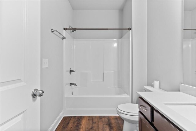 840 Champagne Ln, Hoschton, GA 30548 - bathroom featuring vanity, wood finished floors, toilet, shower / washtub combination, and baseboards