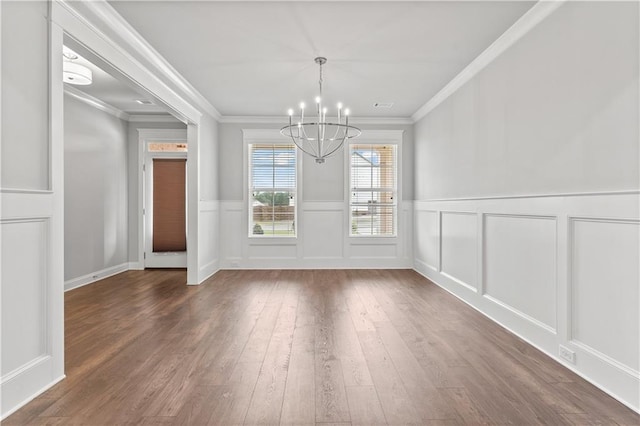 840 Champagne Ln, Hoschton, GA 30548 - unfurnished dining area featuring a chandelier, wood-type flooring, ornamental molding, a wainscoted wall, and a decorative wall