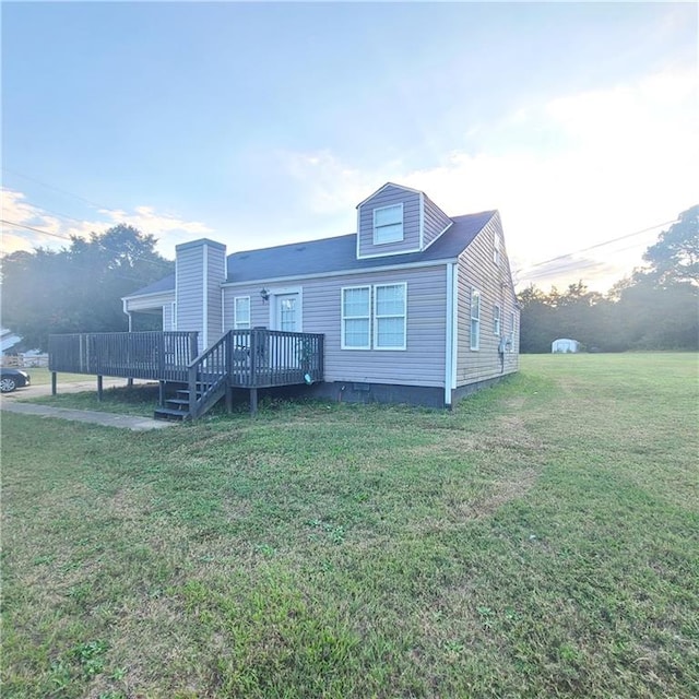 back of house featuring a yard and a wooden deck