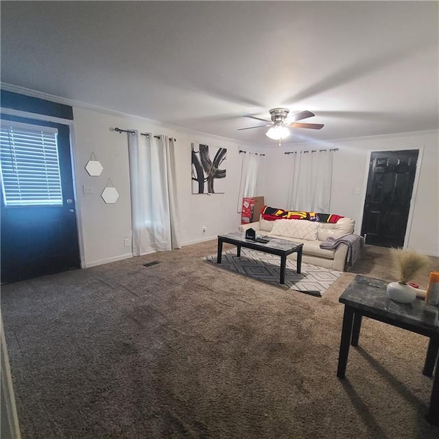 living room featuring crown molding, carpet flooring, and ceiling fan