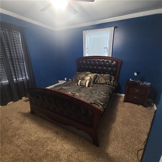 carpeted bedroom with ornamental molding and ceiling fan