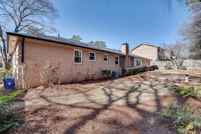 rear view of house with central air condition unit