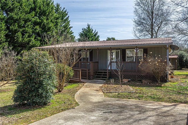 ranch-style home with metal roof, board and batten siding, and a porch