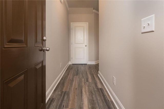 hallway with ornamental molding and dark hardwood / wood-style floors