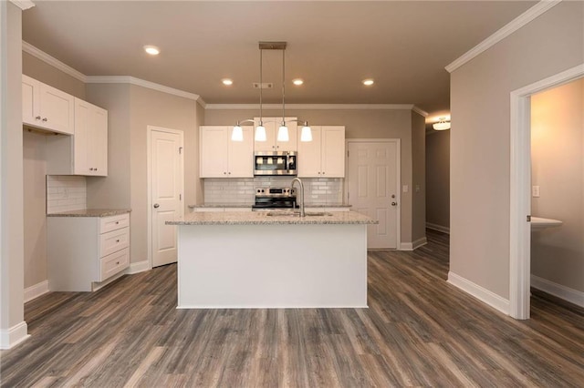 kitchen featuring appliances with stainless steel finishes, sink, a center island with sink, and white cabinets