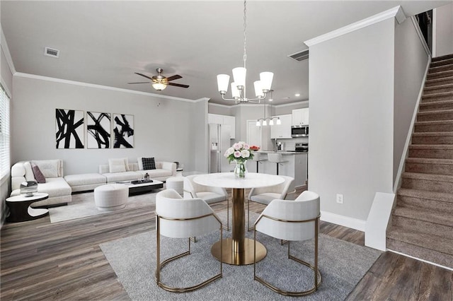 dining area with crown molding, ceiling fan with notable chandelier, and dark hardwood / wood-style floors