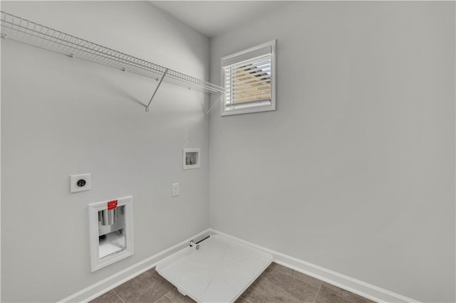 laundry room featuring dark tile patterned floors, gas dryer hookup, washer hookup, and hookup for an electric dryer