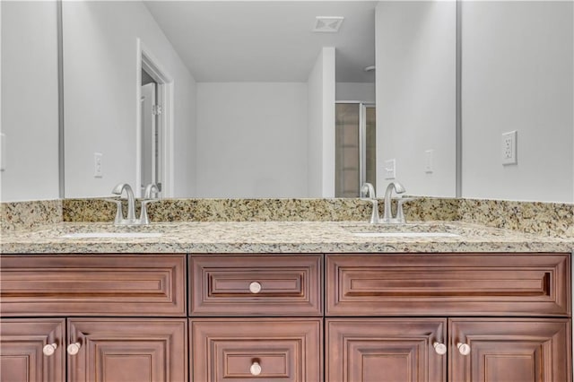 bathroom featuring walk in shower and vanity