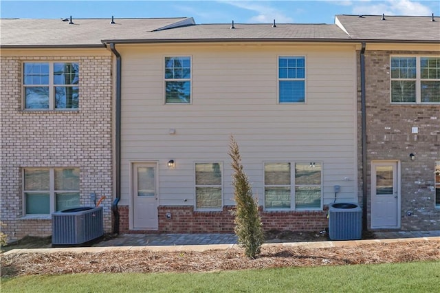 rear view of house featuring cooling unit and a patio area