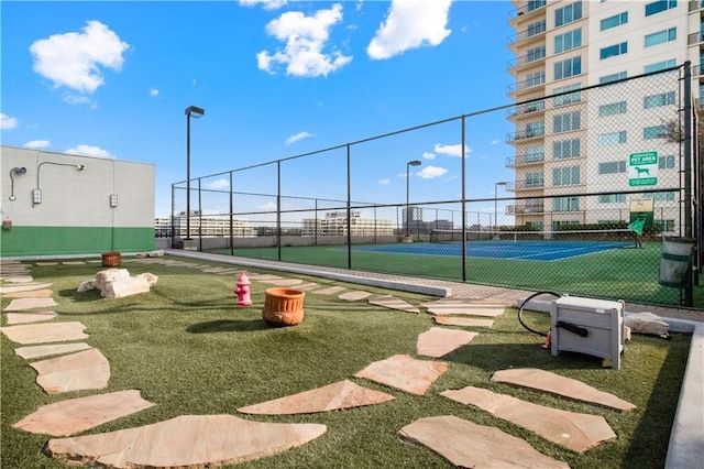 view of property's community featuring tennis court